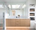 In the bathroom, the white oak vanity is topped with a Carrara marble, and has Kohler plumbing and Rejuvenation sconces.