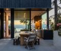 The cast-in-place concrete patio at the back includes an integrated Delta Heat Outdoor Gas Grill from Sutter Home & Hearth. The outdoor entertainment space is immediately off the kitchen and positioned on the lee side of the home to protect from cold offshore breezes.