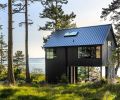 Views from the home include the Sound, a protected wetland, and a bald eagle nest. The home’s exterior utilizes common materials installed unusually. The board and batten siding has been installed in reverse. The dark stain minimizes visual noise from the wood’s knotty appearance.