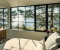 The main bedroom can be fully opened to the ensuite via a sliding door. Traditional paned glazing on the upper floor provides privacy while tempering the home’s modern silhouette. The bathroom tile is Stella Nero Encaustic star tile from Merola.