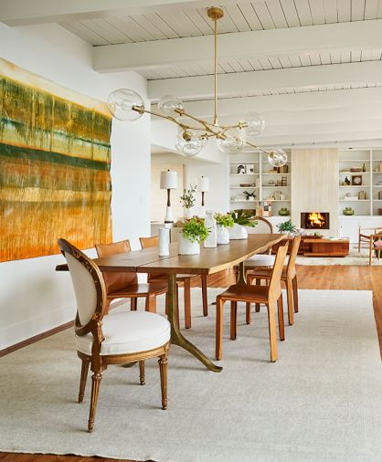 Atop a Christiane Millinger rug, an Anthropologie Nemus dining table mimics BDDW Tyler Hays original. Lord introduced vintage upholstered chairs from Urbanite pairing with Falvey’s Cassina chairs, crowning it with Accent Lighting Fairfax chandelier. Artwork by Falvey’s close friend’s son, Jack Williams.