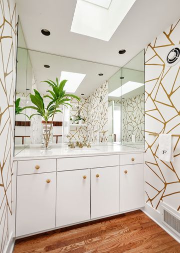 Powder bath’s formerly busy wallpaper replaced by an elegant gold and white Kravet paper. New Red Oak flooring unifies the room with other upstairs spaces. Purist plumbing fixtures by Kohler.