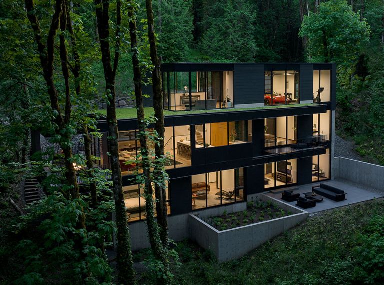 This three-level, four-bedroom, 4,422 square foot house abutting Portland’s Forest Park was completed by William / Kaven Architecture and Metcalf Design & Construction in 2023. The upper level offers green roofing.