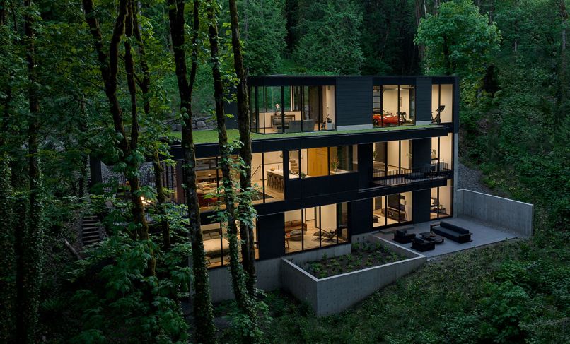 This three-level, four-bedroom, 4,422 square foot house abutting Portland’s Forest Park was completed by William / Kaven Architecture and Metcalf Design & Construction in 2023. The upper level offers green roofing.