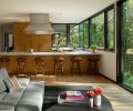 The large kitchen suits the chef homeowner, with white oak cabinetry by Cardinale Fine Cabinetry. The Wolf hood vent and 48  dual-fuel range, and Sub-Zero refrigerator and freezer, are from Basco Appliances.