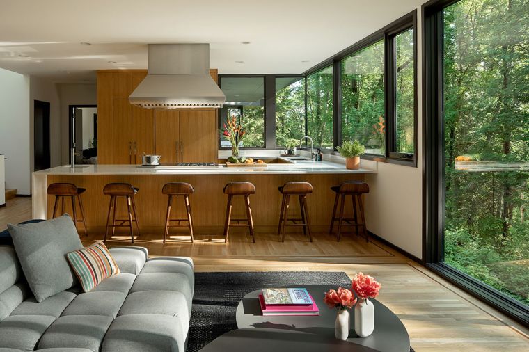 The large kitchen suits the chef homeowner, with white oak cabinetry by Cardinale Fine Cabinetry. The Wolf hood vent and 48' dual-fuel range, and Sub-Zero refrigerator and freezer, are from Basco Appliances.