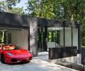 The top floor has road access, so the architects placed the garage and driveway there, bookended by a gym on one side, and an entry “observatory” on the other, where the residents greet guests.