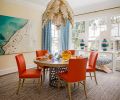 A chic Gilded Palm chandelier by Niermann Weeks floats over a Gregorius Pineo white oak table and chairs with Edelman Leather from Kelly Forslund. Custom Massucco Warner drapery echoes aerial photo “Floating over the Italian Riviera” by Joshua Jensen Nagle.