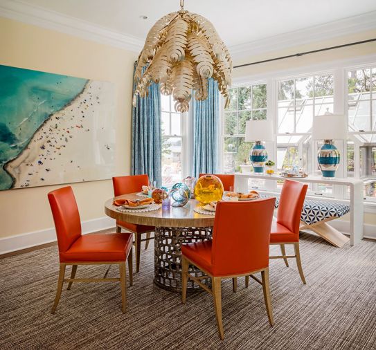 A chic Gilded Palm chandelier by Niermann Weeks floats over a Gregorius Pineo white oak table and chairs with Edelman Leather from Kelly Forslund. Custom Massucco Warner drapery echoes aerial photo “Floating over the Italian Riviera” by Joshua Jensen Nagle.