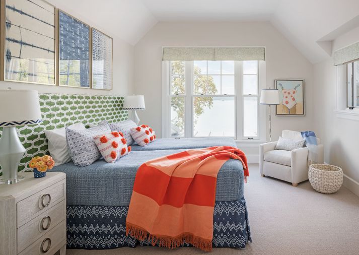 The guest bedroom abounds in color with Massucco Warner’s custom headboard upholstered in Semmakrish fabric with custom bedframe and Anthropologie bedding. Lee Industries small scale club in wool bouclé from J Garner Home accompanies a Visual Comfort polished nickel Chisel lamp. Bernhardt pencil reed nightstands from Leflar LTD showroom sit on either side, holding Arteriors Hasting Glass Lamps.