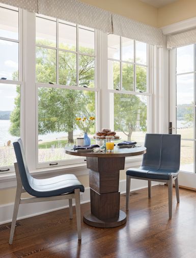 A cozy coffee corner with Ted Boerner block pedestal base walnut table from Terris Draheim and Holly Hunt formed leather and walnut chairs from Jennifer West Showroom. Massucco Warner provided the custom window coverings.