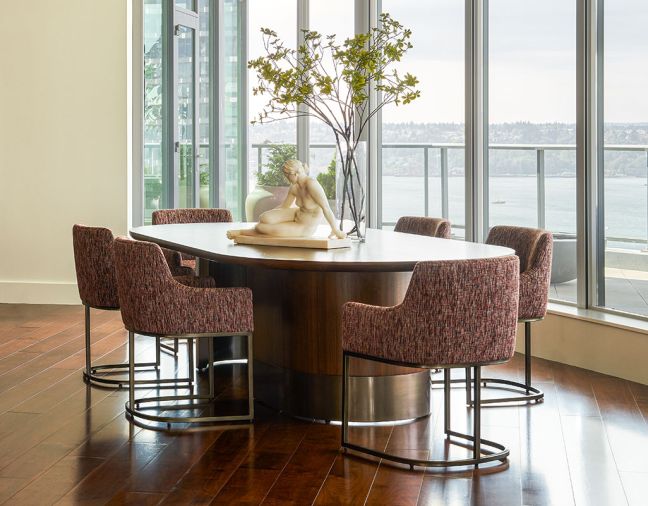 Custom oval dining table from Arden Home with RH chairs in Jim Thompson fabric from Trammell-Gagné.