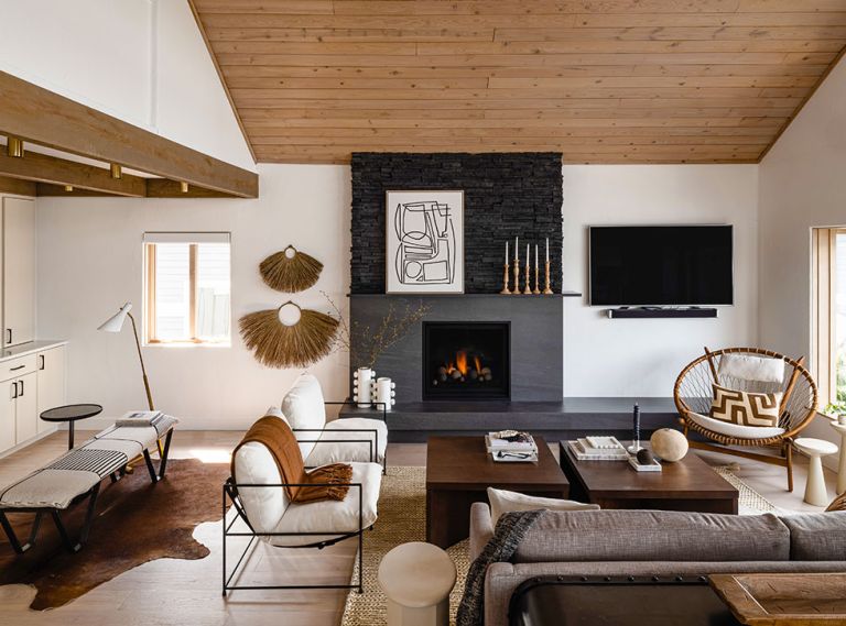 The fireplace takes pride of place in the reworked great room. The honed Basalt hearth and surround from Bedrosians is topped with Pro-fit Alpine Ledgestone and features a Max Heat, Marquis 39 Series fireplace insert.