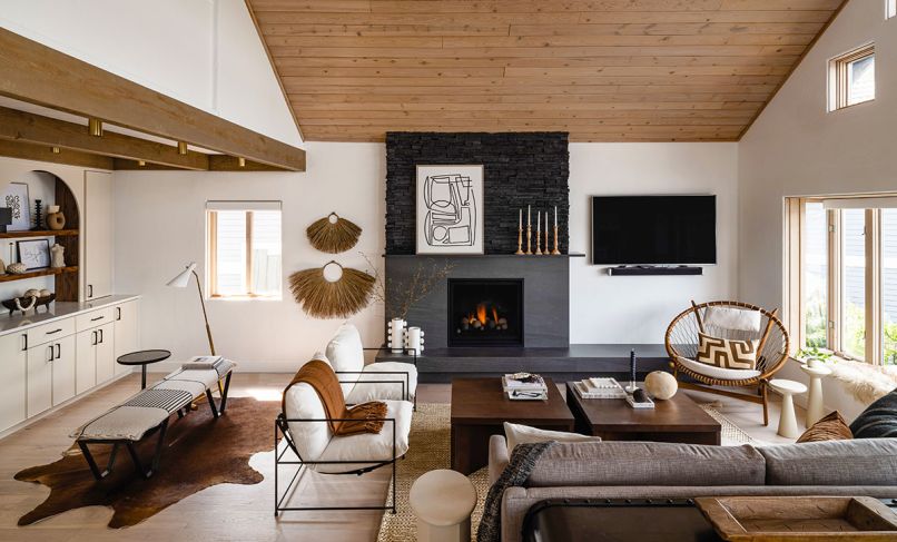 The fireplace takes pride of place in the reworked great room. The honed Basalt hearth and surround from Bedrosians is topped with Pro-fit Alpine Ledgestone and features a Max Heat, Marquis 39 Series fireplace insert.