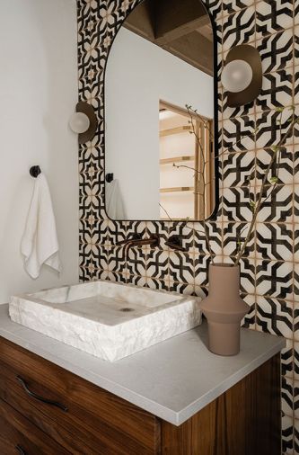 The showstopper of the renovation, the powder room, became the basis of the Santa Barbara theme. The tile included elements to please both homeowners – his darker, warmer aesthetic with her flair for the decorative.