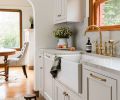 The custom cabinets by Acorn Cabinets feature Massey Unlacquered Brass hardware from Rejuvenation. They’re painted in Benjamin Moore Bruton White, a subtle, warm white with grey and beige undertones. Additional cabinets were added in the existing dining room to tie the spaces together. The Italian brass faucet and side spray are Rohl San Julio Bridge from Ferguson. The Classic Shaker Single Bowl Farmhouse Apron Front Fireclay Kitchen Sink is by Shaws and also sourced from Ferguson.