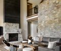 The living room is anchored by the stone wall, and a stone and black steel fireplace, the latter with a Kozy Heat, Carlton 46 gas fireplace from Thomson Heat.