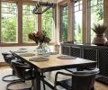 The dining room has Sierra Pacific windows, with a Kasar Rectangular Table from RH and top-grain leather and iron chairs by Fullerton Dining Chairs. An elegant Anaya Sideboard from RH sits beneath the windows.