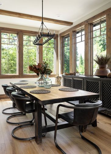 The dining room has Sierra Pacific windows, with a Kasar Rectangular Table from RH and top-grain leather and iron chairs by Fullerton Dining Chairs. An elegant Anaya Sideboard from RH sits beneath the windows.
