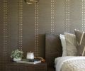 The wallcovering, Studs and Stripes Vertical Rose Gold 5784-V, is from Phillip Jeffries, and the Monterey bedside table is from RH.