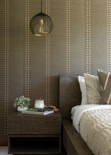 The wallcovering, Studs and Stripes Vertical Rose Gold 5784-V, is from Phillip Jeffries, and the Monterey bedside table is from RH.