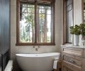 The bathroom has a Luce Di Luna Quarzite countertop, and a Lava Toupe Porcelain floor, both from Stonewood Design.