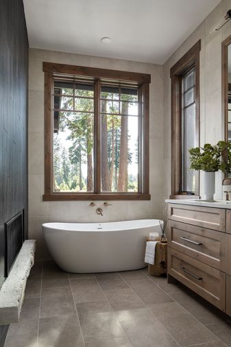 The bathroom has a Luce Di Luna Quarzite countertop, and a Lava Toupe Porcelain floor, both from Stonewood Design.