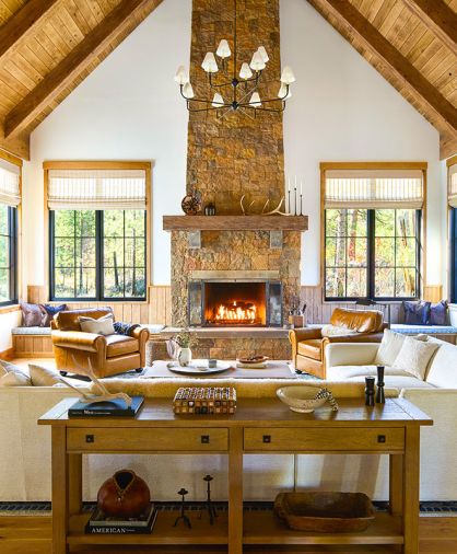 In the great room, a soaring fireplace composed of Montana Moss Rock from Select Stone is a focal point. The Hunter Douglas window coverings are from Cindy’s Window Fashions, the white oak flooring from Pioneer Millworks.