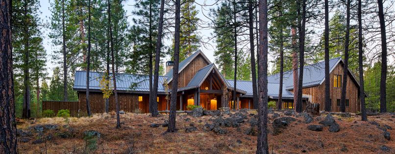 The exterior is covered in tight-knot cedar board and batten siding from Creative Woodworking, with Sierra Pacific windows. Dimensional bluestone pavers guide guests to the entry.