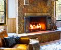 An original Lancaster Leather Chair from RH is a cozy spot by the fireplace.