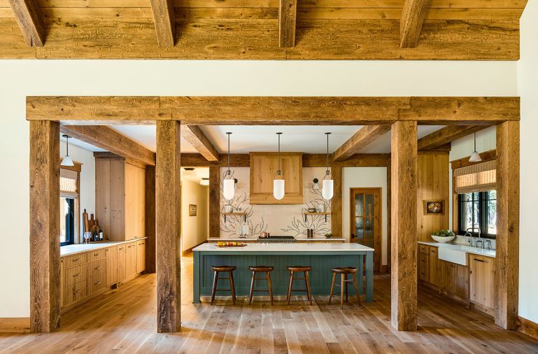 In the kitchen, white oak cabinetry from Oak Grove, joins lighting from Allied Maker and West Elm. A stainless-steel vent hood from Vent-A-Hood is concealed in wood, surrounded by a custom hand painted mural tile backsplash from Tempest Tileworks. The floors throughout are white oak from Pioneer Millworks.