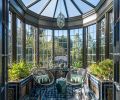 In serious need of restoration to reattach it to the historic home, the interior of the Orangerie also got a facelift, including new electrical to light the Diamond Pendant from Urban Electric. Original tile floors and planters were also restored.