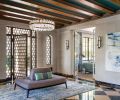 Former entry’s original door. Coup Studio Aquitaine chandelier and Stefan Gulass sconces from Holly Hunt with a Hohla custom Borne Sociable settee with Myles in Pebble Larsen fabric.