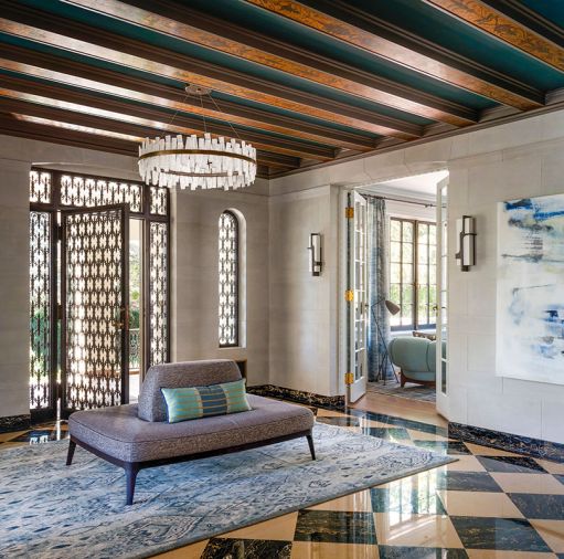 Former entry’s original door. Coup Studio Aquitaine chandelier and Stefan Gulass sconces from Holly Hunt with a Hohla custom Borne Sociable settee with Myles in Pebble Larsen fabric.