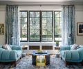 Plush Sao armchairs with Mark Alexander fabric, Pampulha in Aquamarine, by Jean de Merry. Donghia Origami Cocktail Table atop charcoal grey and warm beige undertones floorcovering by Shibori/Hirashi for SHIR Rugs. Gubi Grässhoppa floor lamp in Anthracite Grey.