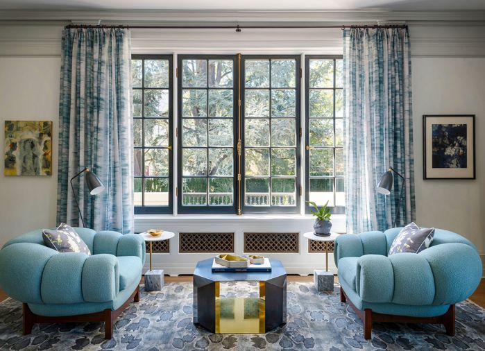 Plush Sao armchairs with Mark Alexander fabric, Pampulha in Aquamarine, by Jean de Merry. Donghia Origami Cocktail Table atop charcoal grey and warm beige undertones floorcovering by Shibori/Hirashi for SHIR Rugs. Gubi Grässhoppa floor lamp in Anthracite Grey.