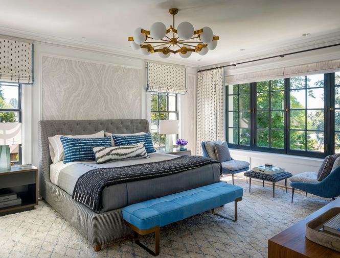 The bedroom offers a vintage chandelier, Hohla custom draperies and custom wood panel and wallcovering from Zak + Fox. West Elm Ziggy bench.