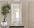 In the entry, the tongue-and-groove wood is brought inside for consistency. On the floor, Stepstone Inc concrete pavers from Willamette Graystone and Oly Studio Annika lighting.