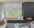 At the fireplace, the glazed brick veneer is from Fireclay in the Absaroka color. The window seat cushion is covered in Mustard Linen by Holland and Sherry.