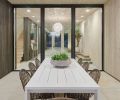 Exterior dining is inviting with Four Hands table and chairs, sourced through Harper House Design.