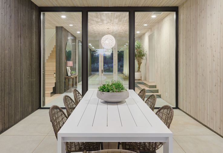Exterior dining is inviting with Four Hands table and chairs, sourced through Harper House Design.