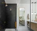 Creating a welcoming bathroom; textured Merola wall tile from Gaudi Hex, Calacatta Gold Honed Marble Penny Rounds from Tilez, brushed brass plumbing from Newport Brass, and Cedar and Moss pendant lighting.
