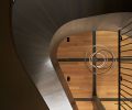 The rift and quartered white oak ceiling is punctuated by a steel grid from Eurocraft Hardwood Floors, making the Cameron Design House “Lohja” chandelier pop.