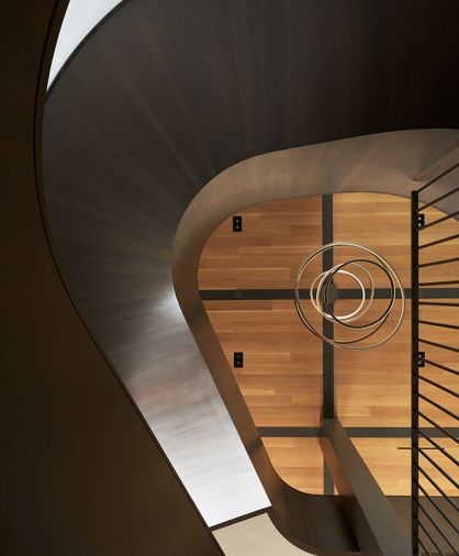 The rift and quartered white oak ceiling is punctuated by a steel grid from Eurocraft Hardwood Floors, making the Cameron Design House “Lohja” chandelier pop.