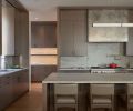 The kitchen features custom stained Northwest Custom Interiors rift white oak cabinetry with Sun Valley bronze hardware, Altura swivel counter stools from Kelly Forslund showroom. Dornbacht Faucet from Best Plumbing, Wolf range and hood insert.