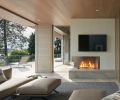 Outdoor space features Mason-Lite fireplace and Indiana Limestone pavers set level to allow water to drain between cracks. Columns trimmed in Ivory Brick from Mutual Materials play off indoor outdoor cedar soffits.