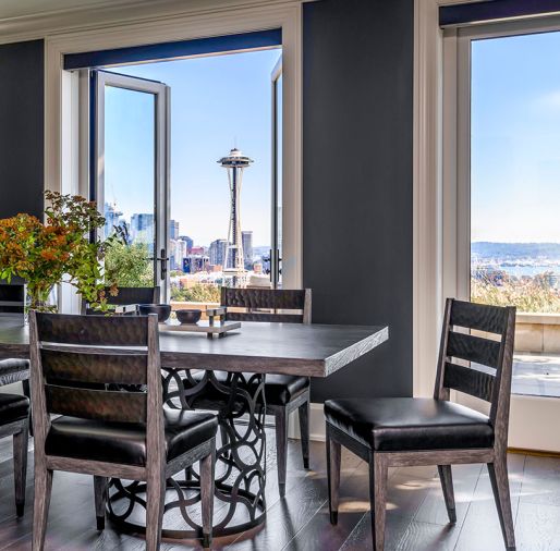 In the dining area, a custom Ignacio rectangular table by Robert James has Bianca Side Chairs from Robert James.