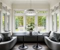 The “game nook” off the living room has custom window seats covered in Lexington vinyl, designed by Ronda Divers Interiors, and created by Classic Interior Concepts. The benches surround a custom Abaco Dining Table by Robert James, with a Lior Round Pendant overhead, from Fine Art Handcrafted Lighting.