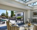 The pool house was reconfigured into a guest suite, and now opens to the pool with new NanaWall folding glass doors. It has a kitchenette, bathroom, and Murphy bed, as well as a Cornerstone Sofa from Century Furniture and Collin Chairs by Jessica Charles.