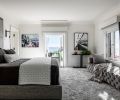 The Cielo Custom Sofa by Nathan Anthony is a favorite spot for Blair to take her morning coffee by the window, as is the exterior balcony. The custom bedframe and headboard is from Castellano Furniture in Portland, and the Ellisse Tempo Sconce from Hammerton.